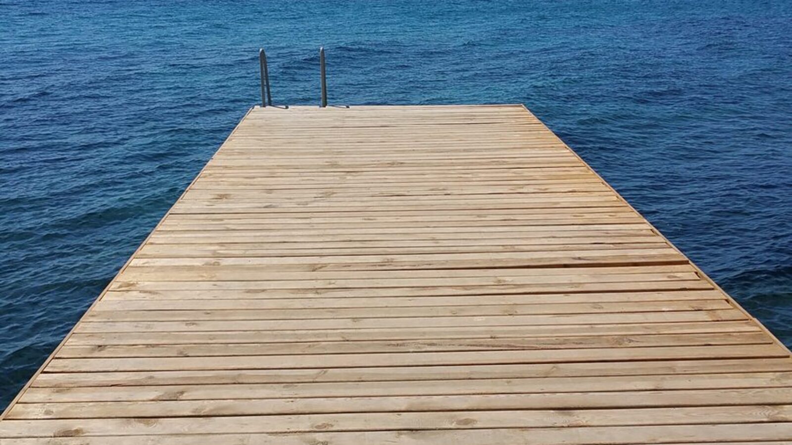Can Therapy Fix ADHD? What Actually Helps 24 A wooden boardwalk crossing grass toward open water, one plank at a time